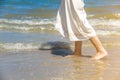 TheÃ¢â¬â¹ Low angle behind woman walking barefoot on beach